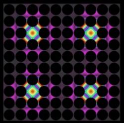 Thermal lattices, shown here, are one possible application of the newly developed thermocrystals. In these structures, where precisely spaced air gaps (dark circles) control the flow of heat, thermal energy can be "pinned" in place by defects introduced into the structure (colored areas).
